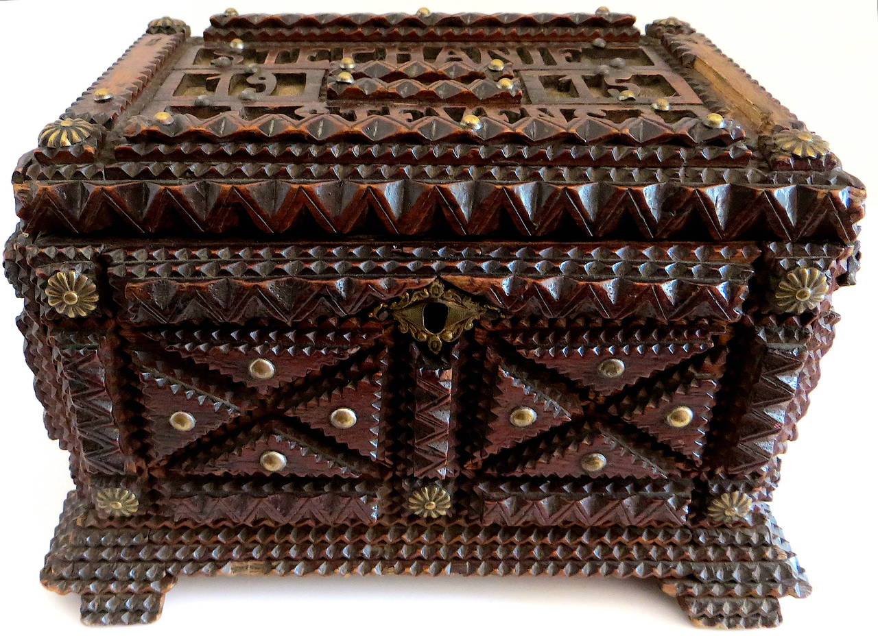 Intricately carved with elaborate open fretwork and hobnail design, this wooden box is dated 