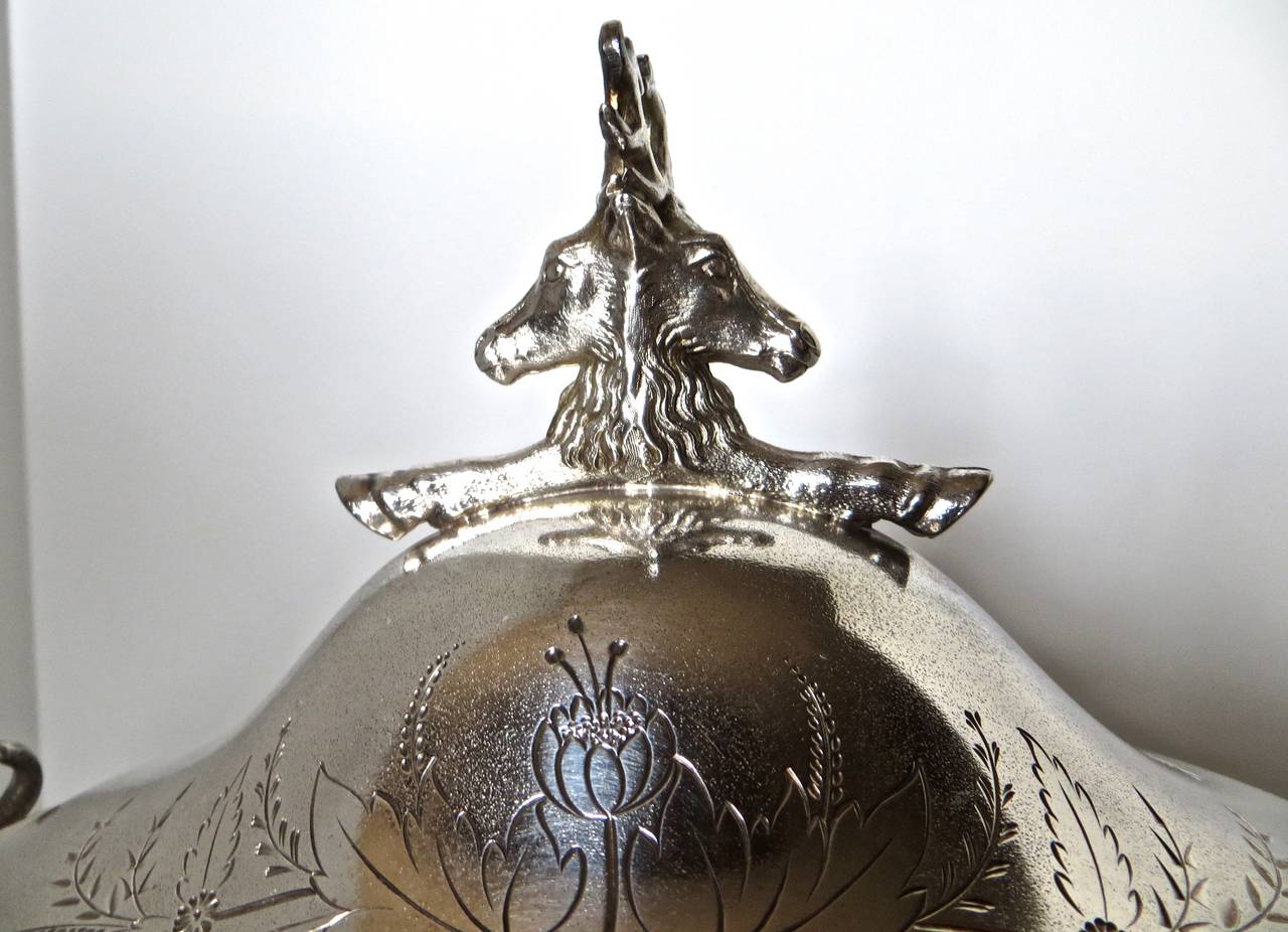 Very unusual western Americana theme silver plated covered tureen, consisting of four feet of cast and silver plated deer heads; rams heads on each end; and opposite facing deer heads at the top of the lid to lift off of the bowl. Sides and top are