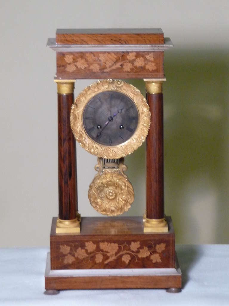 From a Connoisseur for a Connoisseur,  Provenance Adds to Value!
FRENCH MANTEL CLOCK -  Fine Empire Period French Paris Portico Clock,  finely cast bronze gilt pendulum, four column Rosewood with lemonwood flora and fauna inlay pediment case with