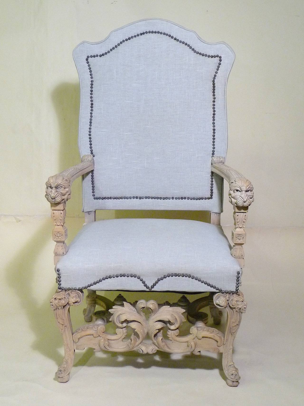 A fabulous 19th century re-styled throne armchair. Originally dark walnut high Baroque Renaissance Revival armchair, bleached and whitewashed--lion head arm carvings, elaborate carved legs with mask at knee and sweeping carvings at the