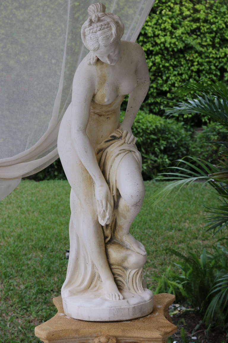 This lovely, classical cast stone statue 'The Bather' of the Goddess Venus, shown drying her foot after bathing, is beautifully lightly weathered and would be the perfect centerpiece in any garden. A lovely face, well-modeled body, gracefully draped