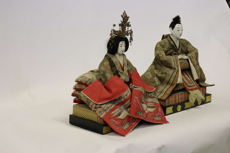 A beautiful very fine pair of Japanese Gofun Meiji period Emperor and Empress dolls, circa 1850-1899.
Depicting the emperor and empress in highly detailed clothing,
traditional crushed bright white oyster shell faces and hands.
Figures in