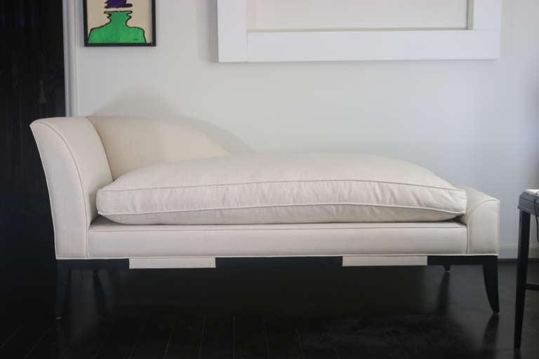 This is a wonderful comfortable chaise lounge by
Designer & Manufacturer:  Tommi Parzinger-  Parzinger Originals
it has been re-upholstered in 2008 in a fine white linen, with down and feather fill cushion to give a luxurious feel and