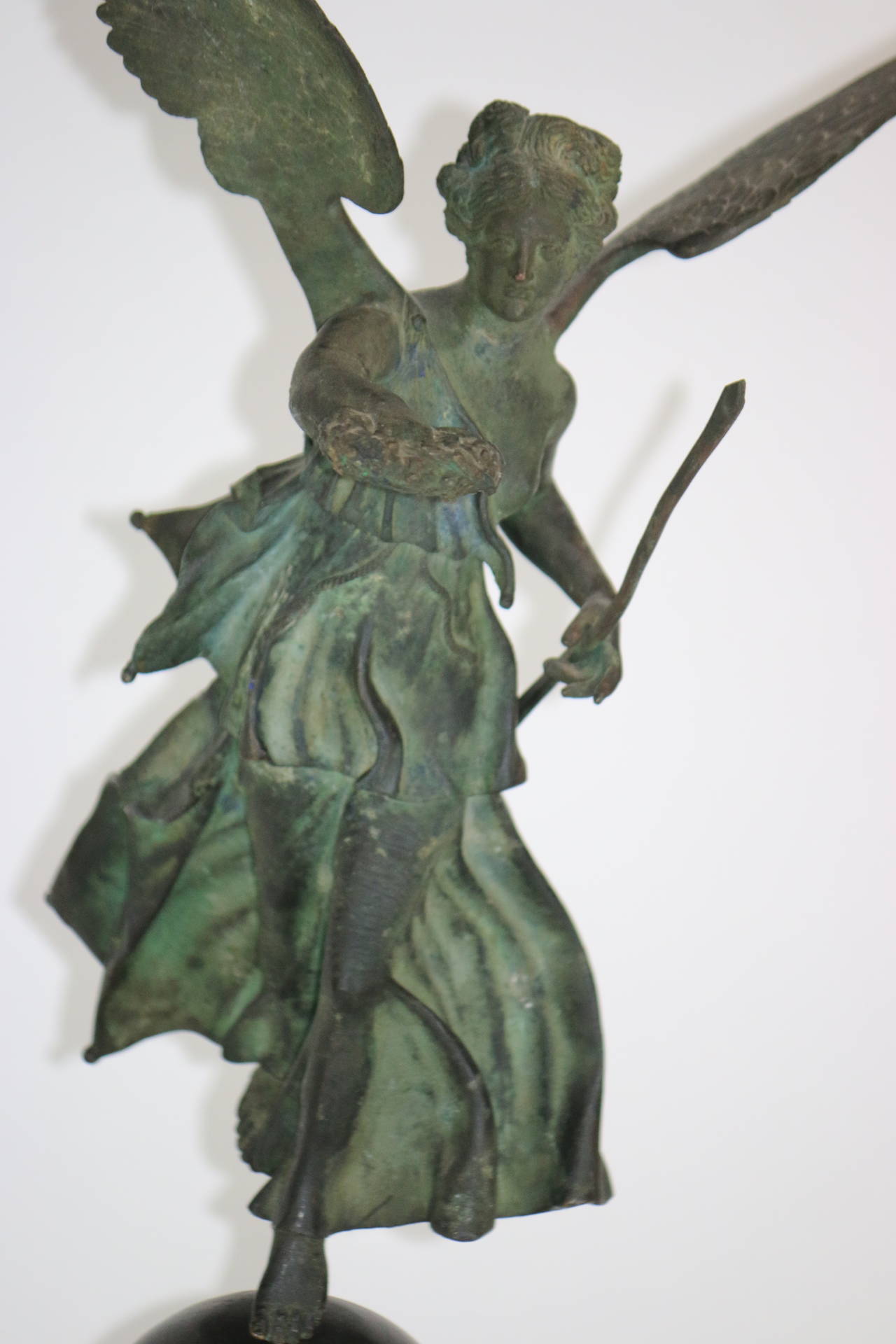 19th century bronze winged Victory with wonderful archaistic patina on a Rouge marble base. A marvelous addition to an inspired modern interior as well as a classical decor.   32