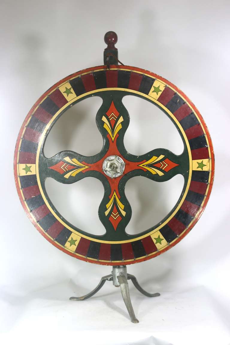 Antique Arcade Americana Folk Art gaming wheel of fortune floor model in vivid color on wood stand with metal legs.
This wheel is branded and marked as 'The Green Star' Mfg. by French Game and Novelty Co. Milwaukee 36