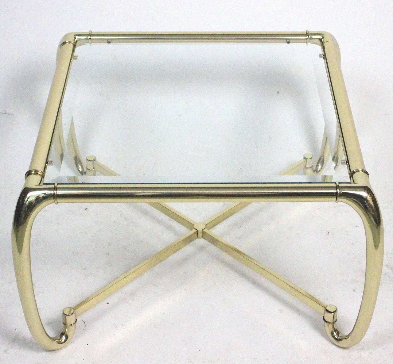 Mid-Century Modern manufactured by  Mastercraft sculptural brass square coffee table with glass inset top. The brass has been recently polished.

From the Edith Hale Harkness Estate--Society Heiress and Philanthropist from Standard Oil Fame.

