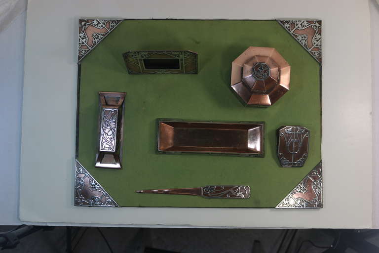 An Amazing Complete 7 Piece Desk Set. A beautiful Art Nouveau design by famed Heintz Art Metal. Sterling Silver on Bronze & Copper.-set consists of:blotter, blotter roller pad, paper clip holder, ink-well, tray, picture frame, letter opener- marked