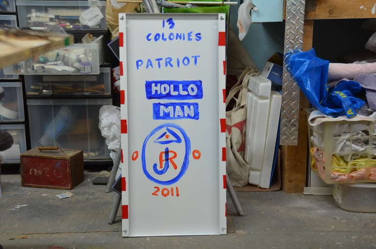 ‘HOLLOMAN -’13 Colonies Patriot-Eeny Meany Miny Mo'Sculpture-- Who Will Be The Chosen -Contemporary Artist Ronn Jaffe's Iconic Figure Holloman-- 13 Moveable Magnetic Metal Components on White and Red Striped Metal Panel -and Enamel Paint- signed.