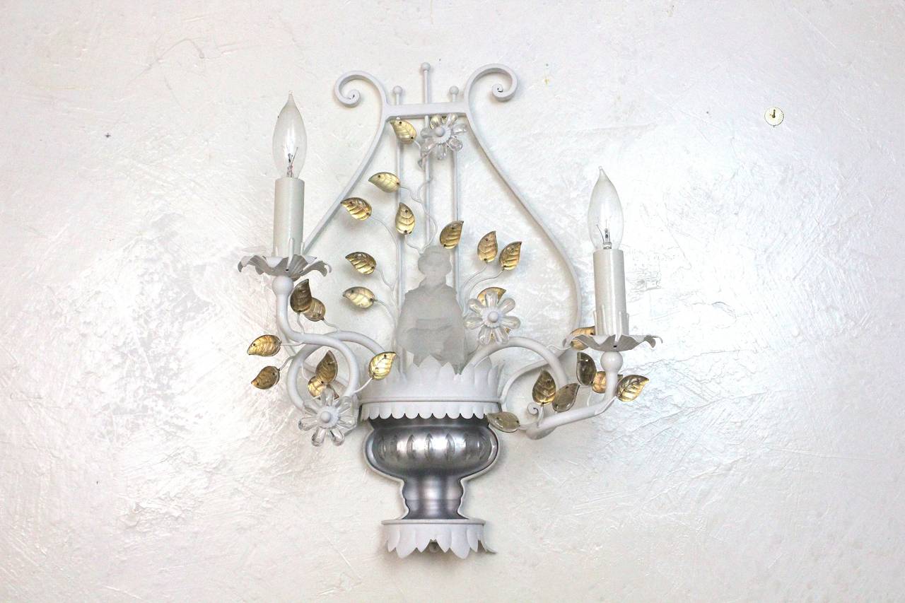 A beautiful Sherle Wagner Hollywood Regency large tole white metal two-light chinoiserie sconce with silvered carved glass pedestal between two tole metal scalloped edge trims-gilt glass leaves, large white center crystal flowers and a most unique