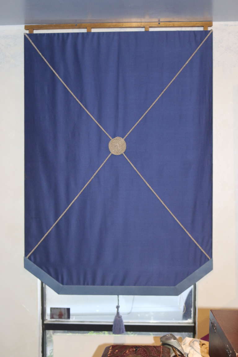 A very Chic pair of window shades--They do not raise or lower, they are stationary -the cobalt color Bergamo swiss silk taffeta is mounted on a board, the reverse is covered in a white cotton lining cloth--a silk twisted corded X design on the