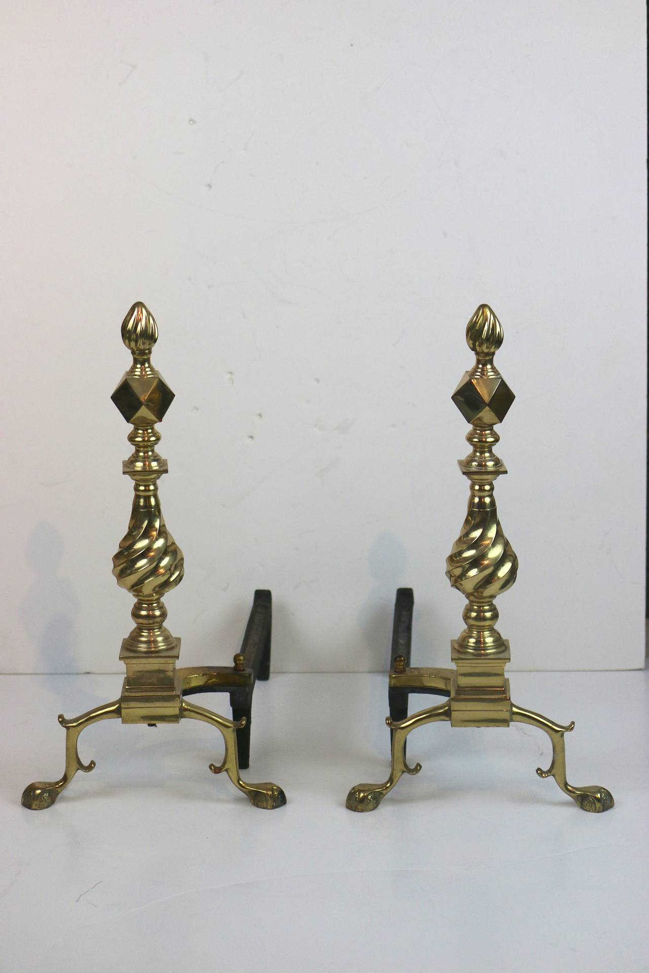 A Pair of Federal Style Polished Brass Andirons, Diamond Center Top and curvilinear brass detail stem, each one raised on ball and claw feet.
19 1/2