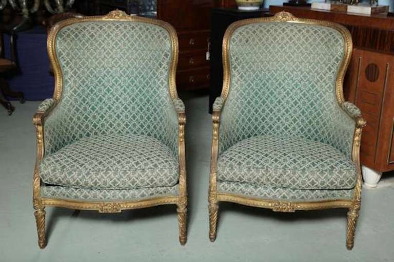 A pair of 19th century very eloquent mellowed aged giltwood carved Louis XVI style bergères with upholstered armrests, very fine carvings on this very sophisticated pair of throne chairs,
Lovely green matelasse brocade upholstery fabric in good