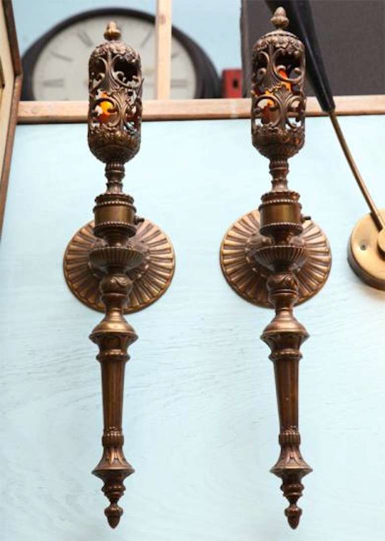 A spectacular and important pair of articulated aged copper on brass formerly Gas lit converted to Electricity- wall mounted torchieres sconces from a french chateau. Majestically chased and turned details with scrolling canopy wall mount---26 in.