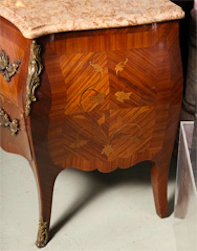 A very fine French large commode with ormolu mounts kingwood, rosewood and floral marquetry commode of Louis XV style, second half of the 19th century of serpentine form, the serpentine shape marble top above two long drawers and a shaped