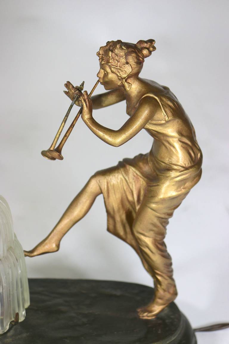 This charming whimsical very fine figural lamp features two gilt bronze ladies-nicely detailed face, hair, and dress, representing music- one playing a flute, the other playing a triangle, both joyously dancing in front of a central light with a