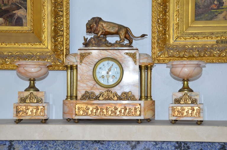 Impressive very fine French Empire onyx clock with Egyptian inspired doré bronze Ormolu-fine chasings of swans and Egyptian figures with a bronze lion and snake on a rock sculpture atop after Bayre, with a beautiful pair of matching onyx garnitures