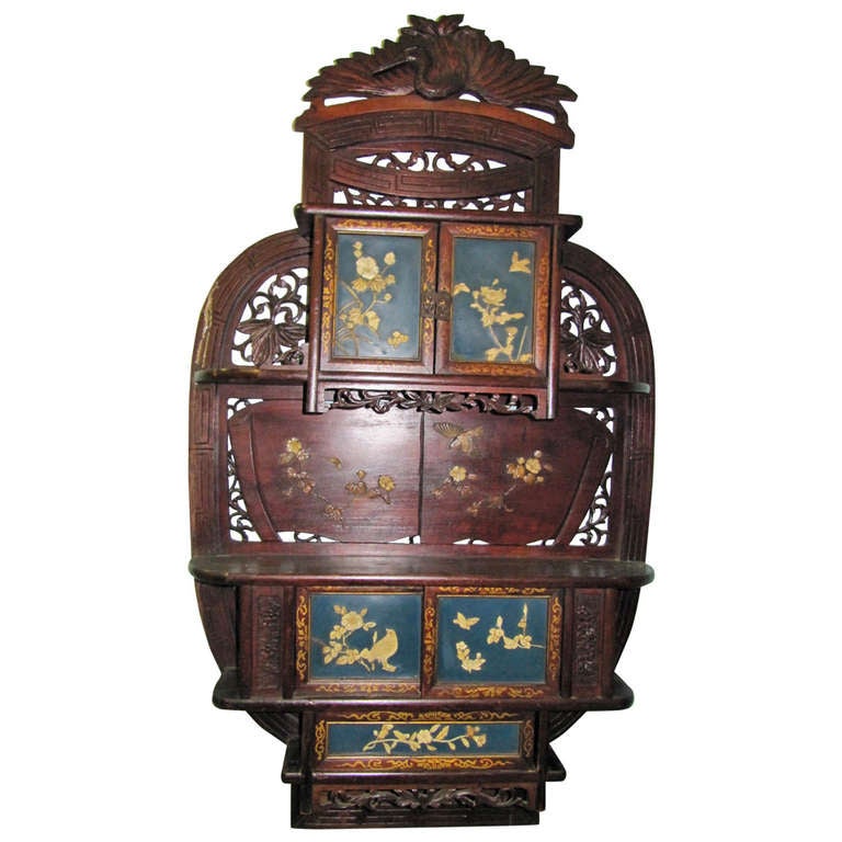 This is an exquisite rare Japanese carved hardwood wall cabinet/display, Shodona, Meiji Period, 19th century. Refined details as in the pierced cresting top centered with a crane, wings spread over an arrangement of sliding doors below, open