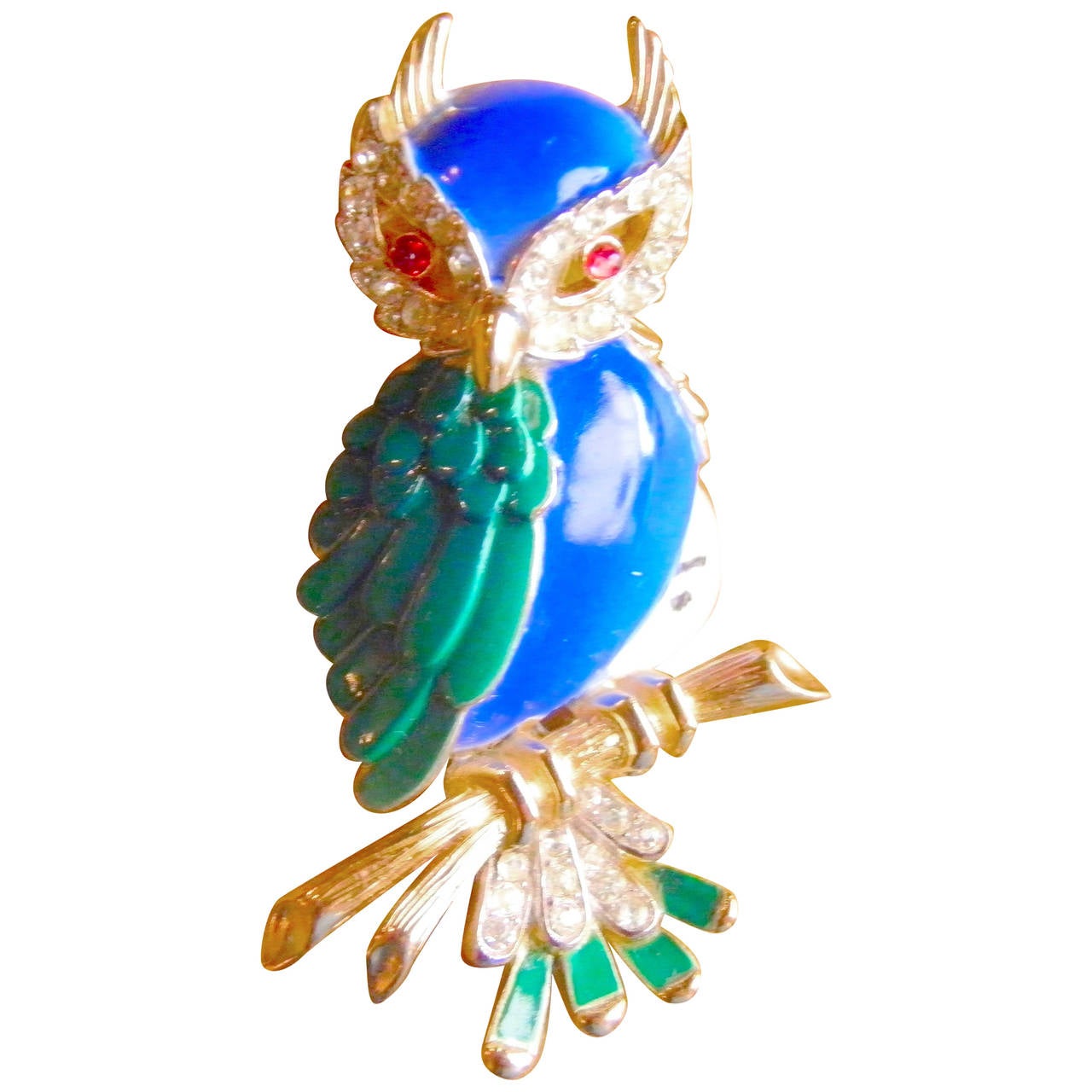 A high fashion Trifari signed figural owl- brooch beautiful cobalt blue enamel breast and head, green enamel feather pattern wing with sparkly ruby color stone eyes outlined in rhinestone and rhinestone talons all on heavy gold plate form -- marked