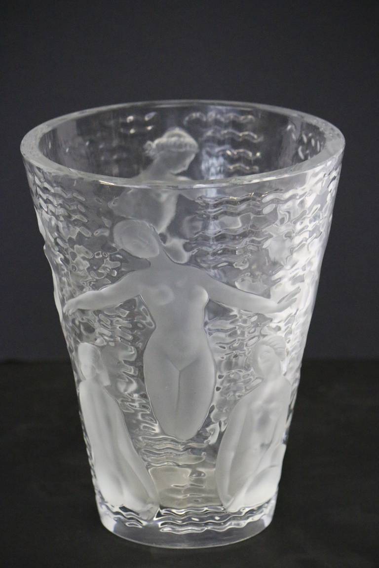 Circa 1960 Lalique vase with nude water nymphs in clear and frosted imagery, signed on the bottom Lalique, R in a circle, France. Assuring it is an original Lalique.
Thanks to the contrast between transparency and satin finishing, the crystal comes