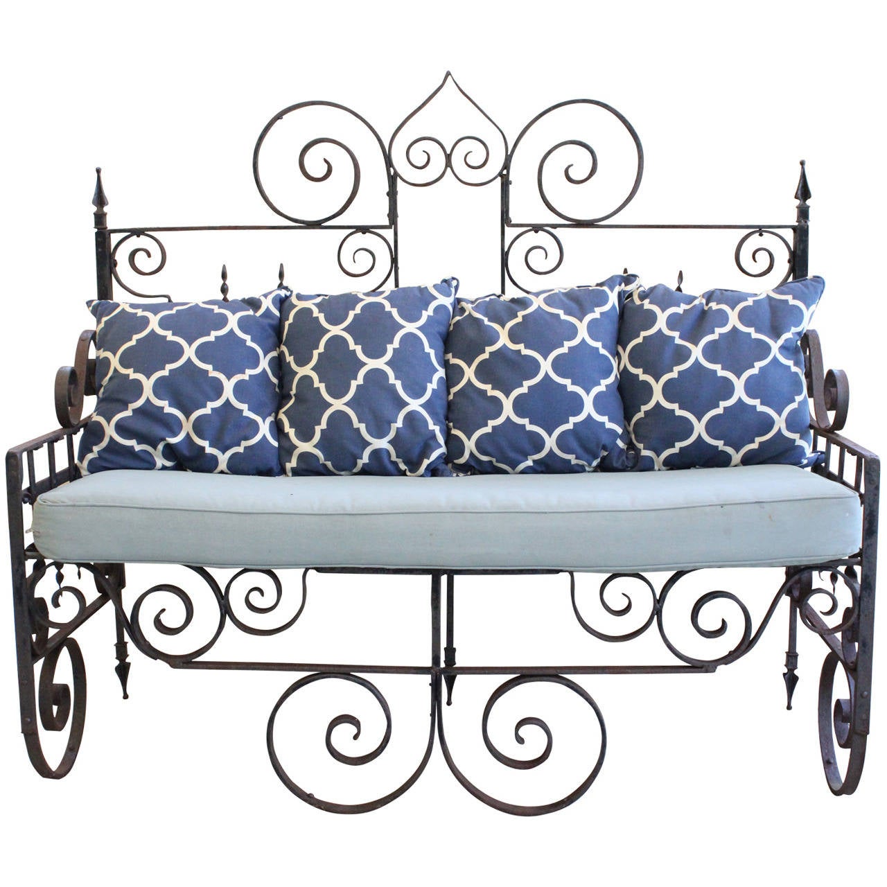 A 'tour de force design! hand-forged American garden wrought iron bench sofa. with intricate scroll motif, raised centre pediment and arrow head finials and rear feet with a very special aged rusticated patina. This is a unique rare bench with