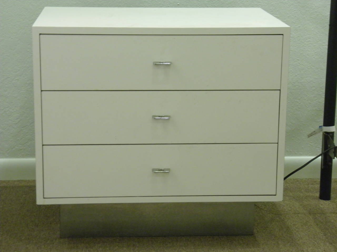 1970s vintage Mid Century Modern Milo Baughman Style White Lacquered Pair of Chests or Night Stands with natural wood interior drawers with original modern chrome pulls. Each chest is fitted with three spacious wood drawers on a matte chrome plinth