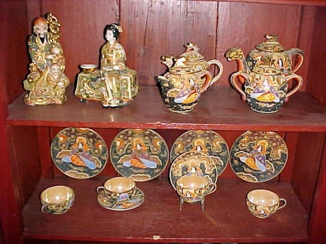 21 piece Japanese Satsuma tea service, several periods circa 1920s....relief decoration, painted, enameled and gilt surfaces covered with continuous scenes of mythological relief dragons and fish amid groups of raise outlined figures, saints, floral