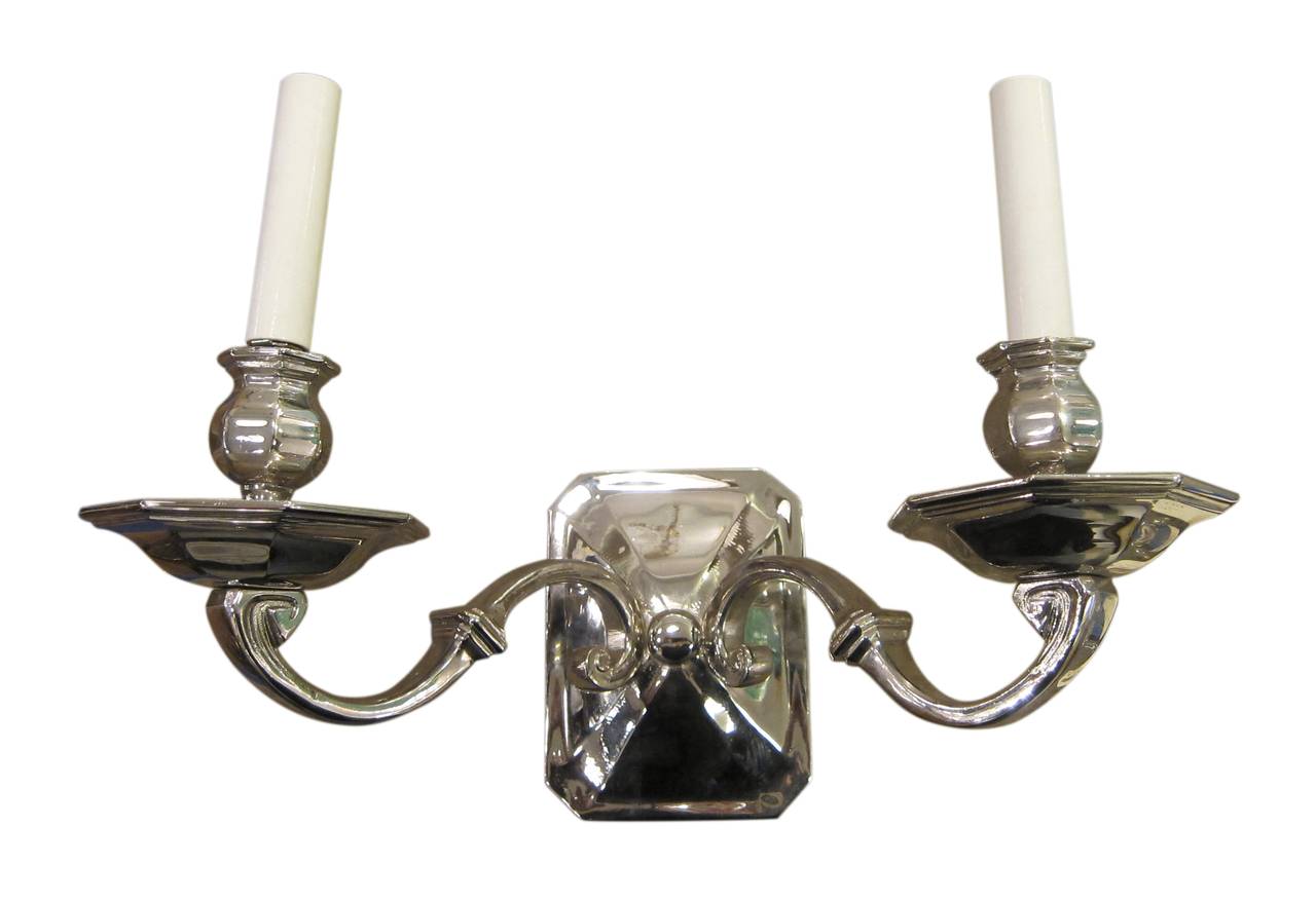 1940s pair of French Art Deco two arm sconces in polished nickel over bronze. This can be seen at our 400 Gilligan St location in Scranton, PA.
