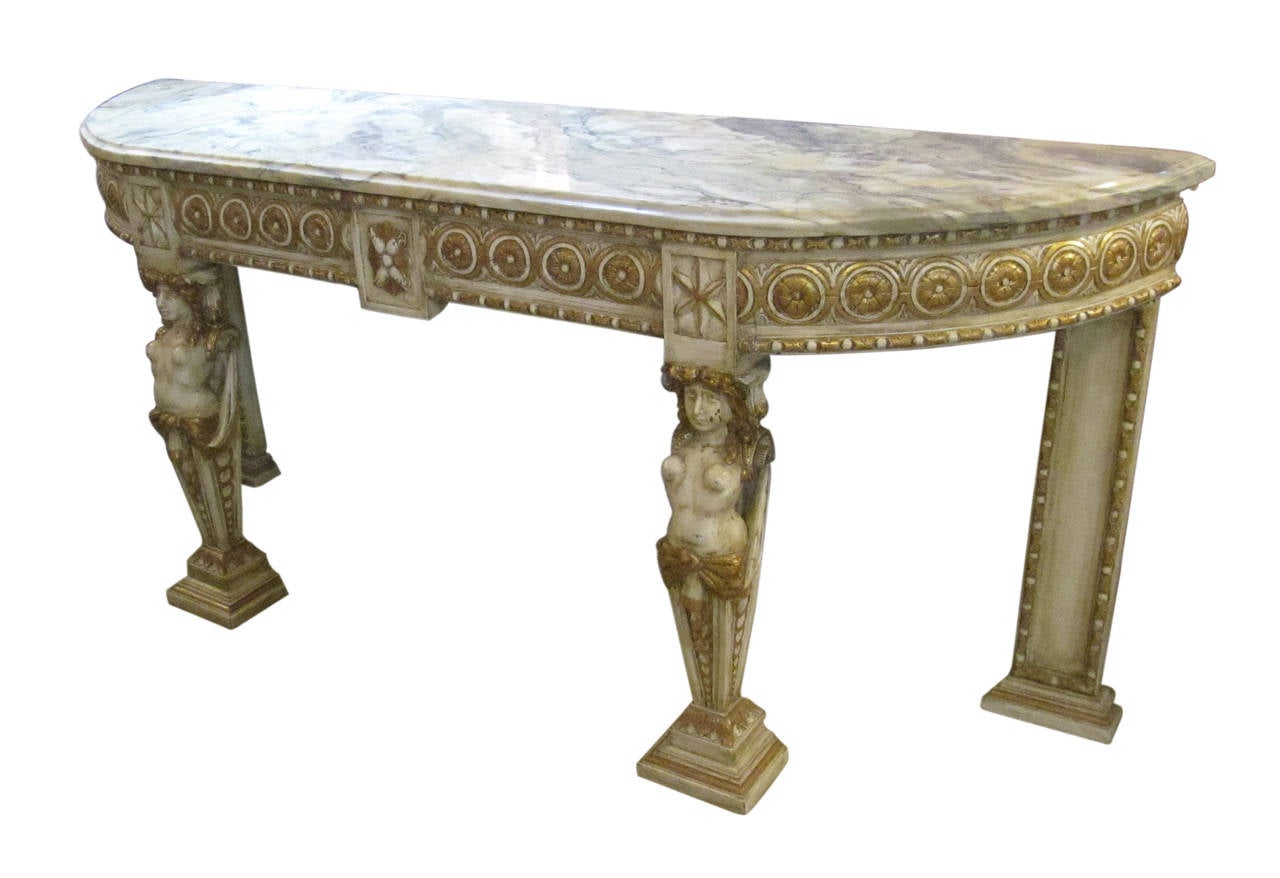 1940s marble topped console made of carved wood, gilded and painted base. This item can be viewed at our 5 East 16th Street location in Manhattan.