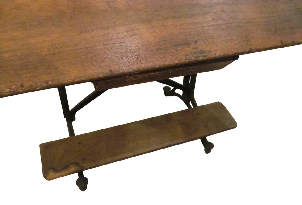 1910 adjustable drafting table with functional drawer, wheels and built in footrest. This table is full of adjustments and in beautiful shape. This item can be viewed at our 5 East 16th Street location in Manhattan.