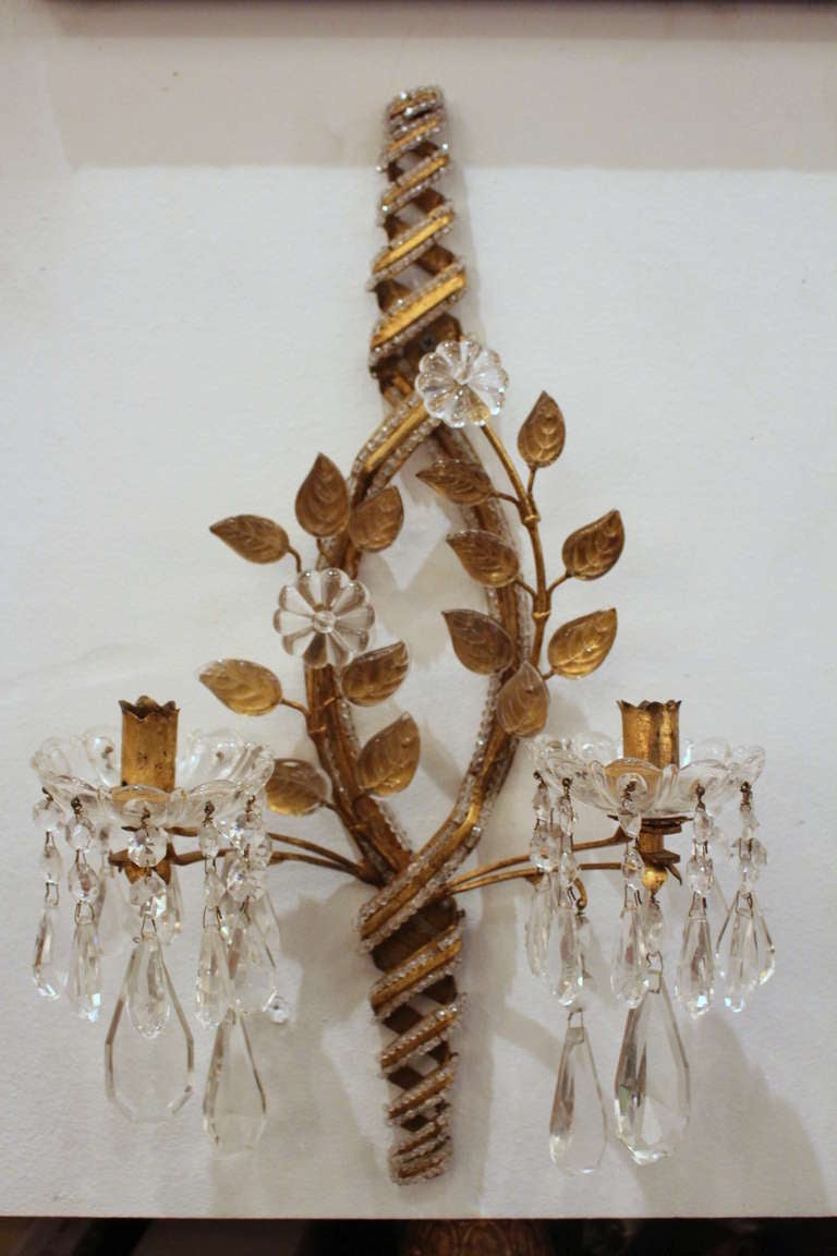 Hand-wrought metal work with an intricate beaded design including leaf shaped crystals.
