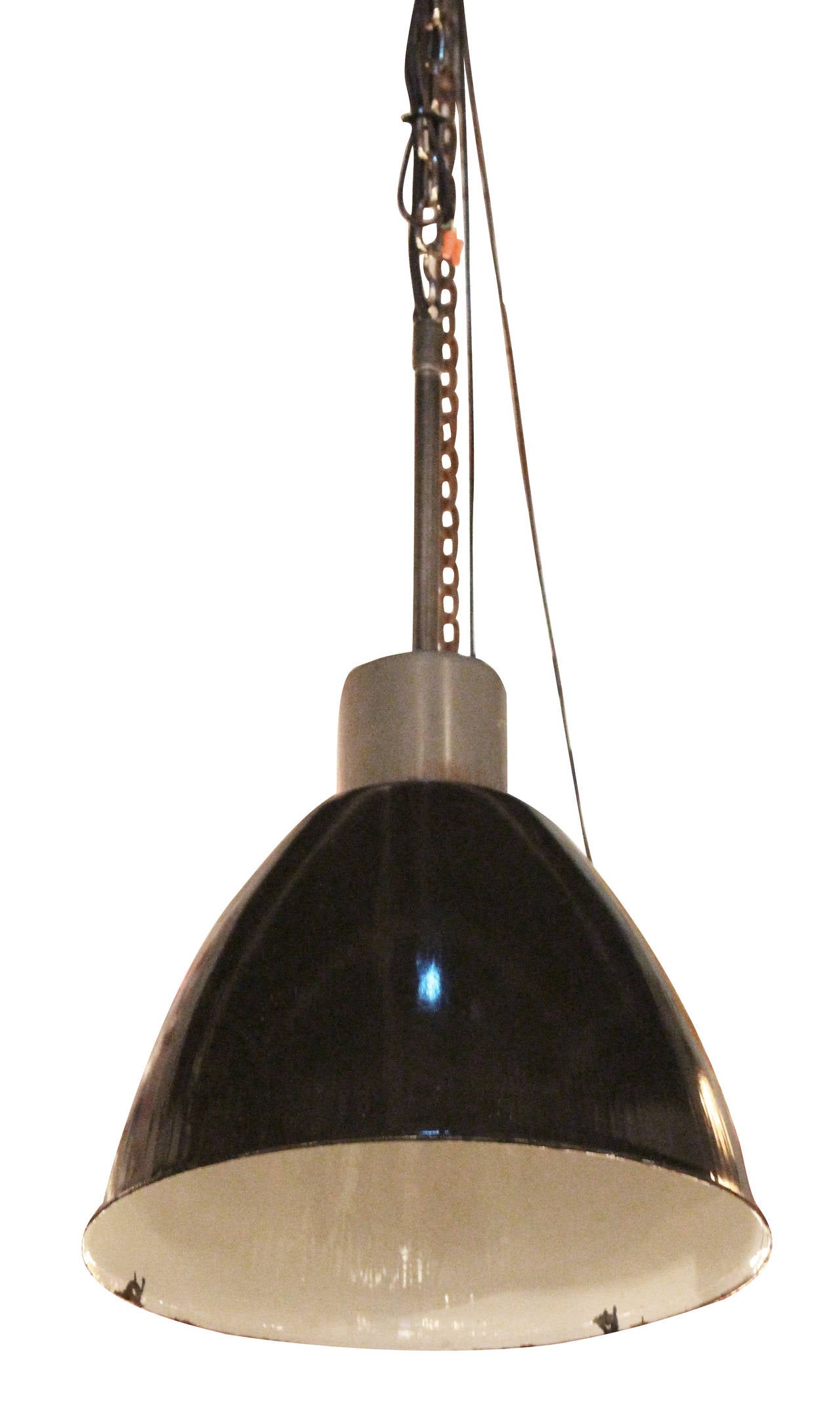 These are great oversized enamel Industrial lights from Germany. Old new stock never used. The exterior is slightly speckled black enamel with a clean white enamel interior. The simple gray painted fitter on top makes these lights easy to retrofit