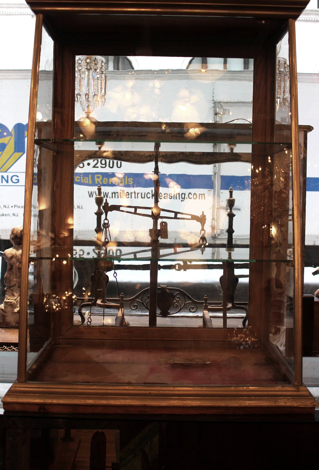 Display case with wavy glass and original lock and key. Two glass shelves. See through back. This can be seen at our 149 Madison Ave, Manhattan location.