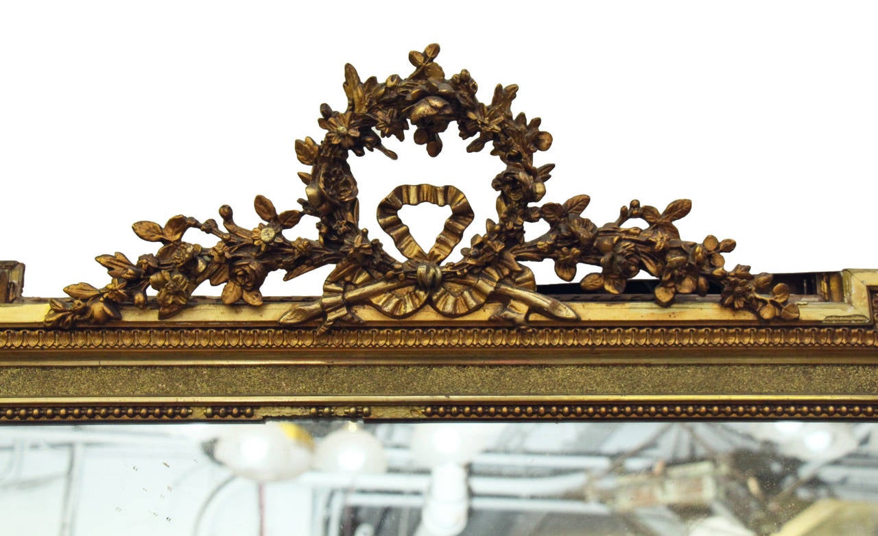 Tall and ornate French mirror. This item can be viewed at our 302 Bowery location in Manhattan.