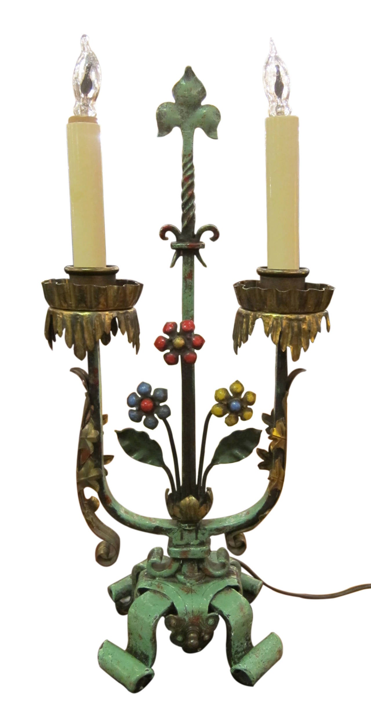 Pair of floral table lamps fashioned out of painted iron and bronze. This can be seen at our 2420 Broadway location on the upper west side in Manhattan.