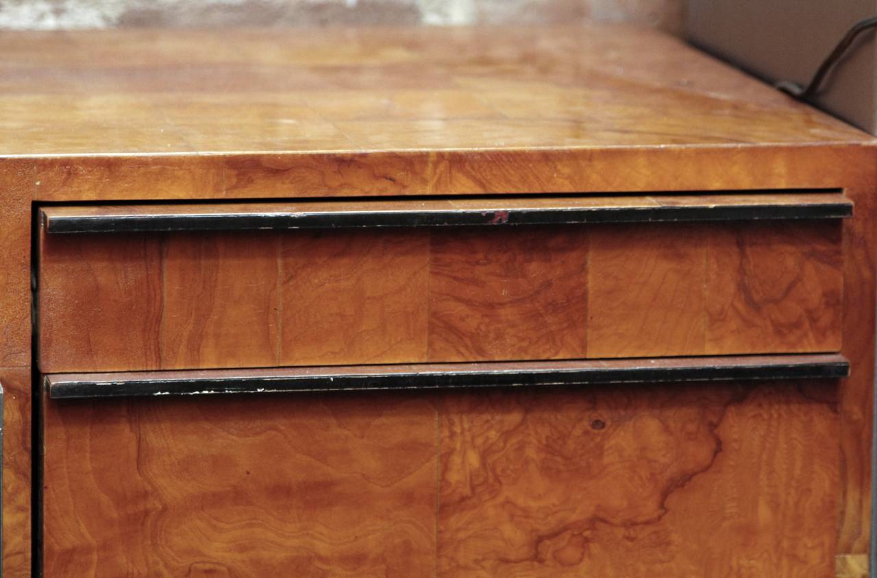 Salvaged out of Miami, this is an attractive credenza with burled walnut veneer and a lacquered finish. Designed by American furniture designer and sculptor Paul Evans. The inset interior cabinet has two shelves. The credenza has two drawers on