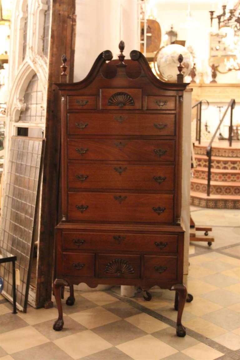 This is a beautifully done mahogany Chippendale style highboy chest with a scroll top and carved shells on cabriole legs with claw and ball feet.  The finish is in excellent condition - this was done in the 1940's and is a replica of a much earlier