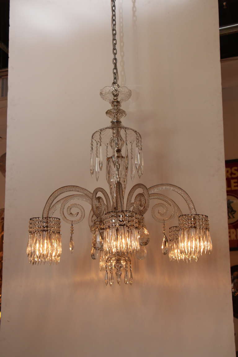 Baccarat crystal chandelier with six lights. Each light is surrounded by hanging crystals. Please note that in these photos the crystals look champagne colored but they are actually clear.  This item can be seen at our 149 Madison Avenue store at