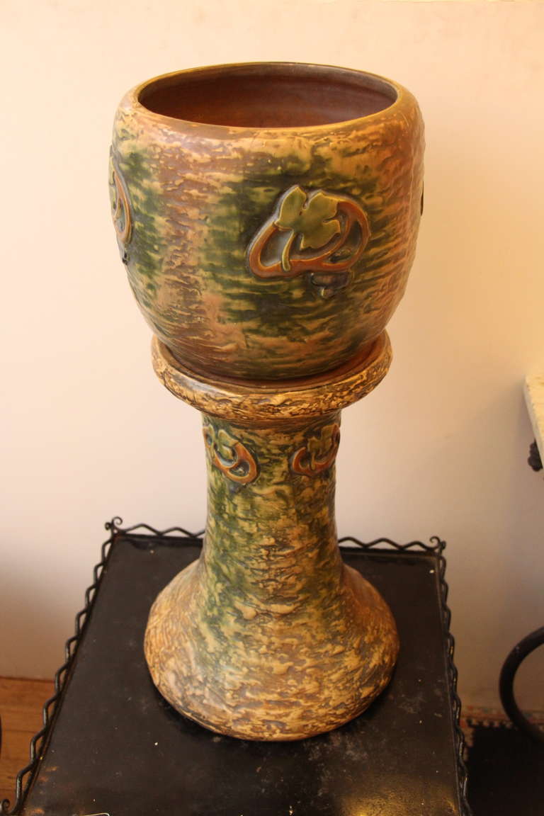 Ceramic green and brown jardiniere with pedestal with a matte glaze. This can be seen at our 400 Gilligan St location in Scranton, PA.