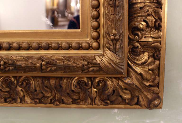A pair of ornate 19th century mirror frames with distressed mirror glass. This item can be seen at our 149 Madison Avenue store at 32nd St in Manhattan.