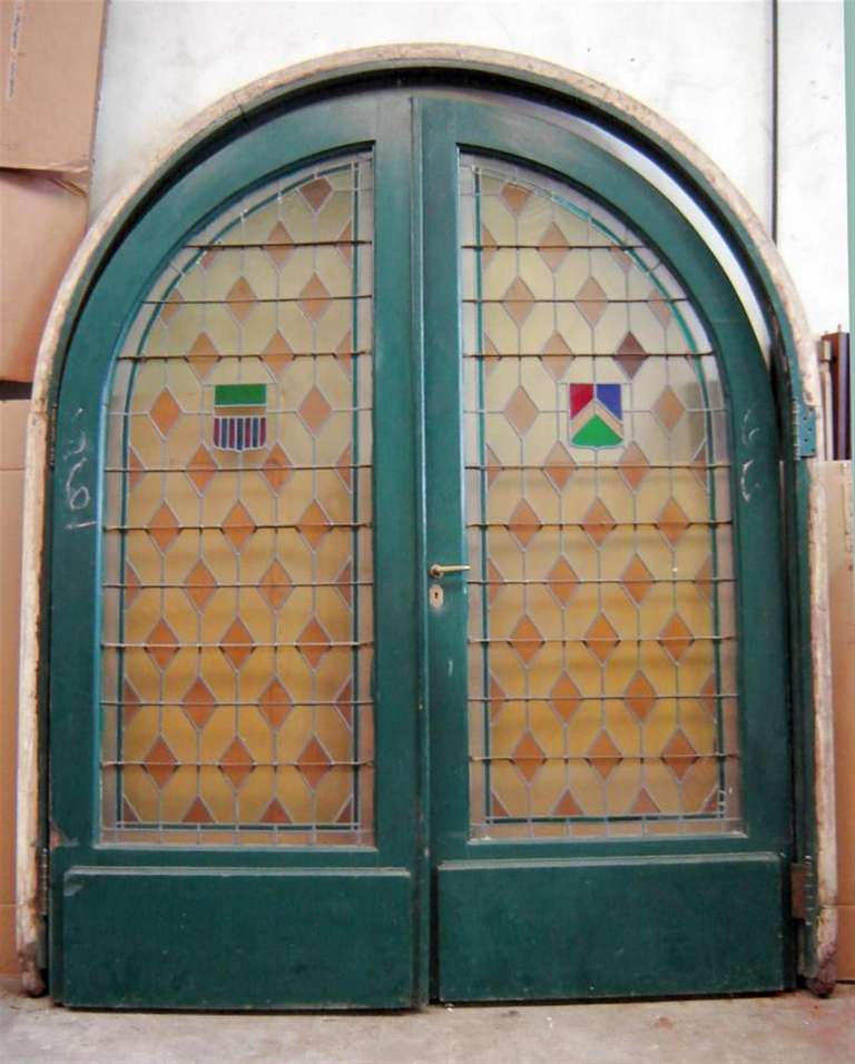 Large pair of arched leaded and stained glass doors that were originally installed in a home in Buenos Aires, Argentina. This item can be seen at our National Warehouse in Scranton, PA.