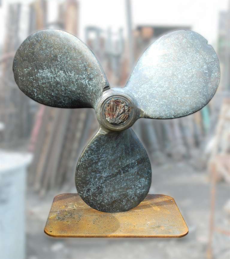 Mounted onto an iron base. This propeller was made in the late 1970s. Weighs about fifteen hundred pounds. It's intact, but does have scratches and chipped edges. Price is firm. This item can be seen at our National Warehouse in Scranton, PA.