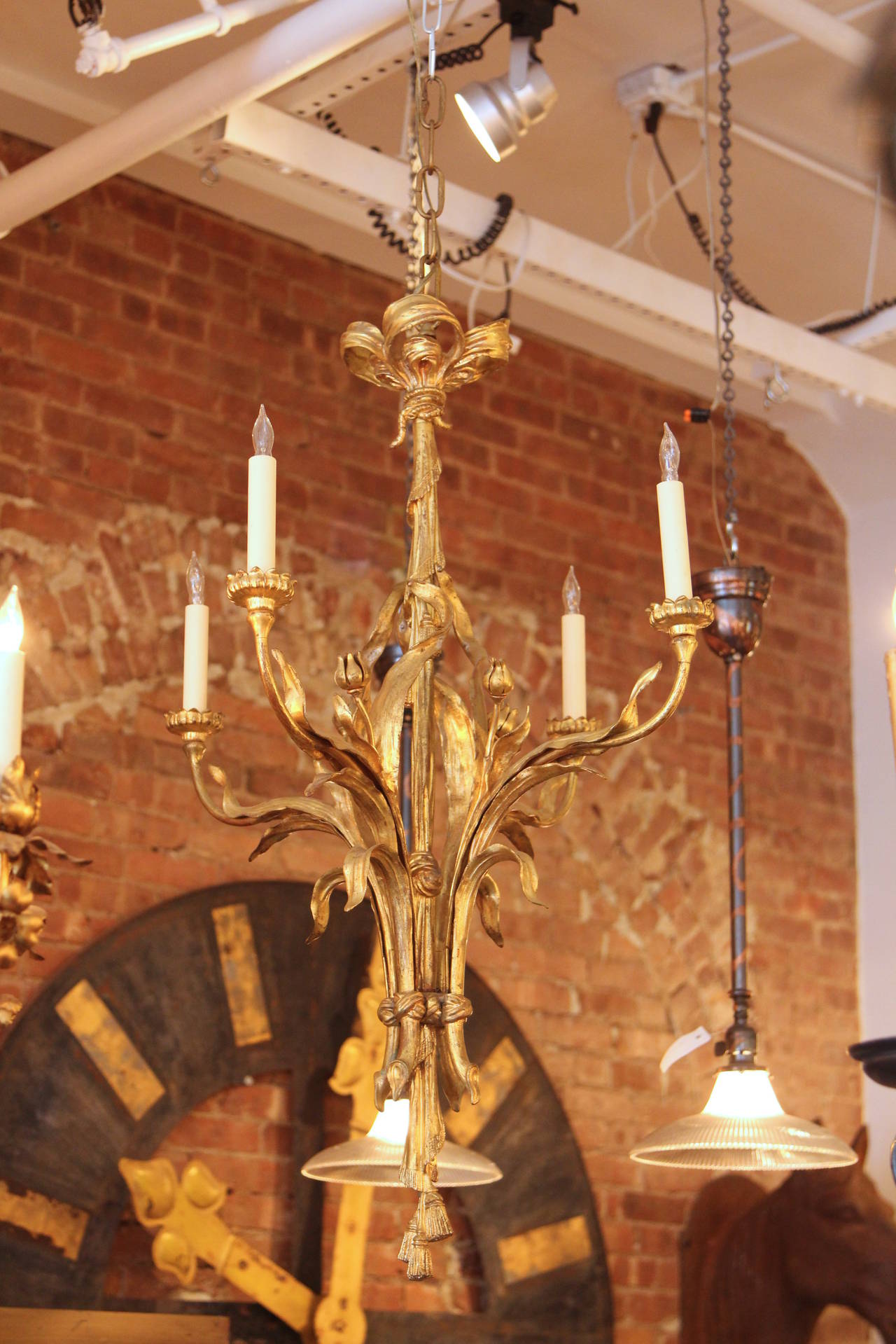 This chandelier is fashioned out of ormolu bronze. Detailing on the hanging fixture includes flowers, leaves, a serpent, braided rope, ribbons, tassels and four lights. Made in France in the 1900s. This item can be viewed at our 302 Bowery location