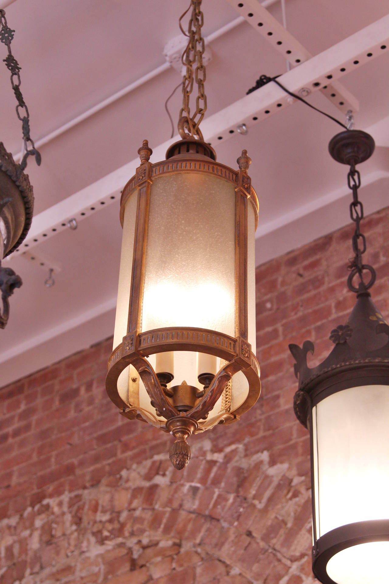 Large cast bronze lantern with frosted glass from the early 1900s.  It showcases four lights.  This item can be viewed at our 302 Bowery location in Manhattan.