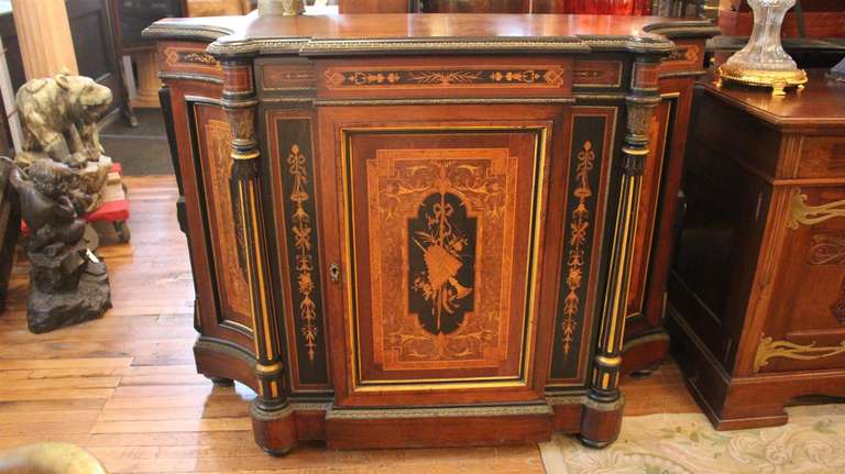 Beautiful 19th century American rosewood credenza with spectacular marquetry. Door opens to reveal amazing all bird's-eye maple interior. Bronze mounts on columns, top, bottom and middle edges. Side doors open to reveal storage space with shelving.