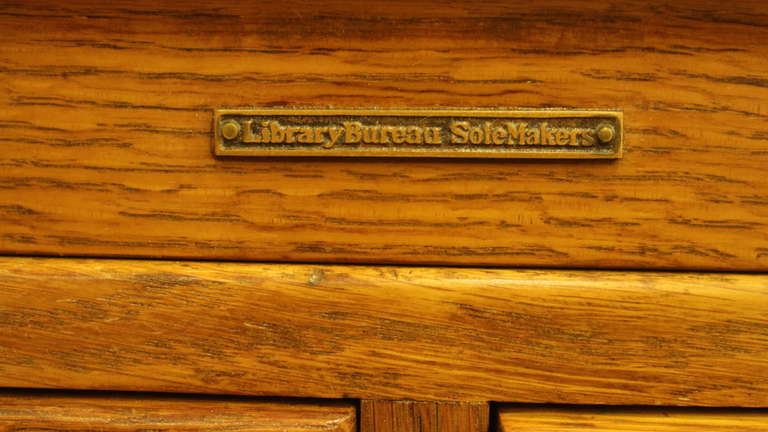 A very electric mix of compartments on this turn of the century library piece. Containing regular size file drawers, shelves and smaller drawers. Comes with original brass hardware. SoleMakers was a leading manufacturer of high end office furniture.