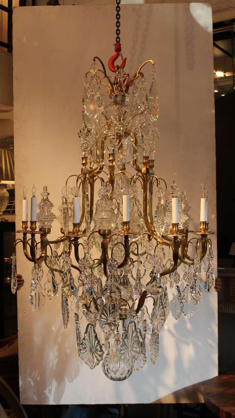 Large bronze and crystal Louis XV style chandelier, hung with tear drops, prismatic rosettes, and terminating with a cut crystal ball. This item can be seen at our 149 Madison Ave location in Manhattan.