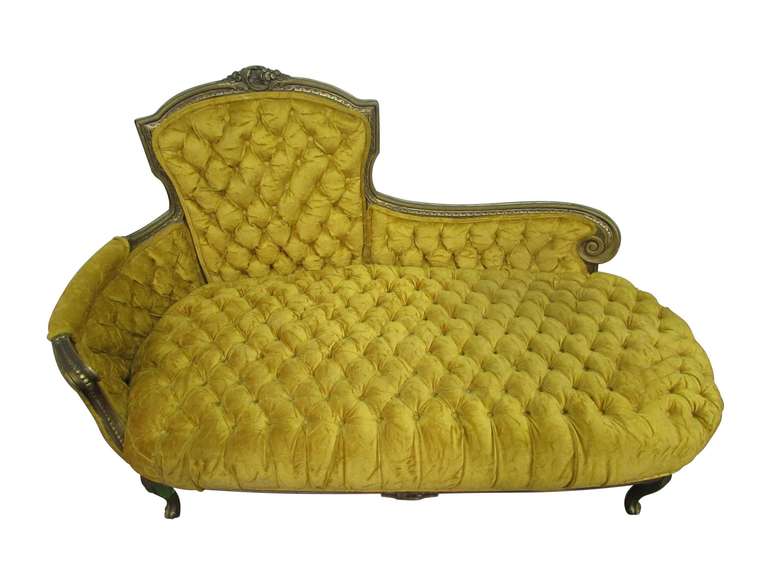 Unique carved Victorian frame with yellow tufted upholstery.