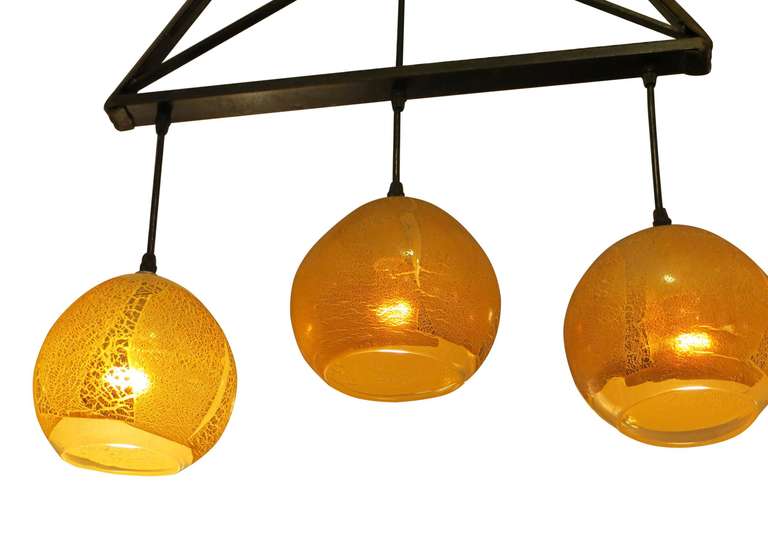 2009 Mid-Century Modern hand blown glass three light pendant. This can be seen at our 302 Bowery location in Manhattan.