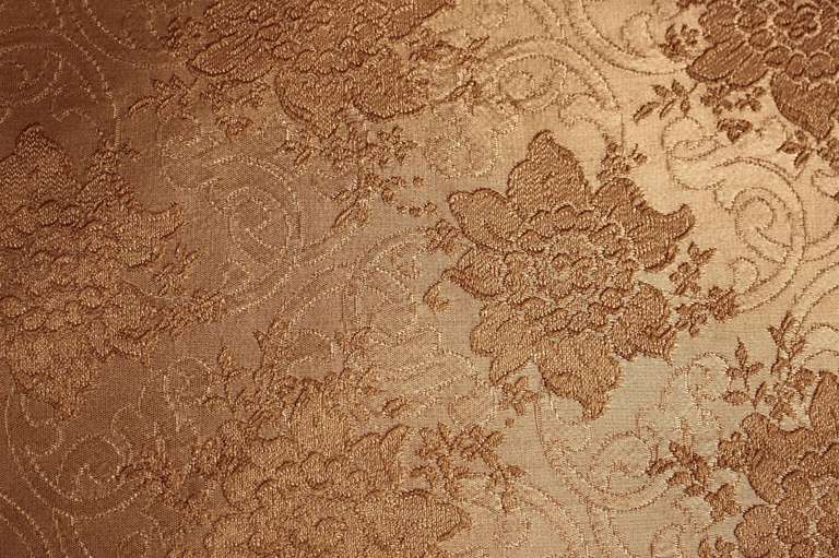 This Victorian set can either separate into two separate love seats or can be pushed together to form one large couch. Both have carved wood edges with gold gilded paint and original creme with floral print upholstery.