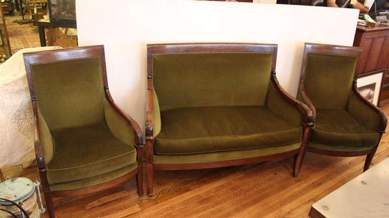 Beautiful three-piece 19th century French Empire salon set with settee and two armchairs with carved walnut frames, rivets and green fabric. Very good condition. This item can be viewed at our 149 Madison Avenue location.